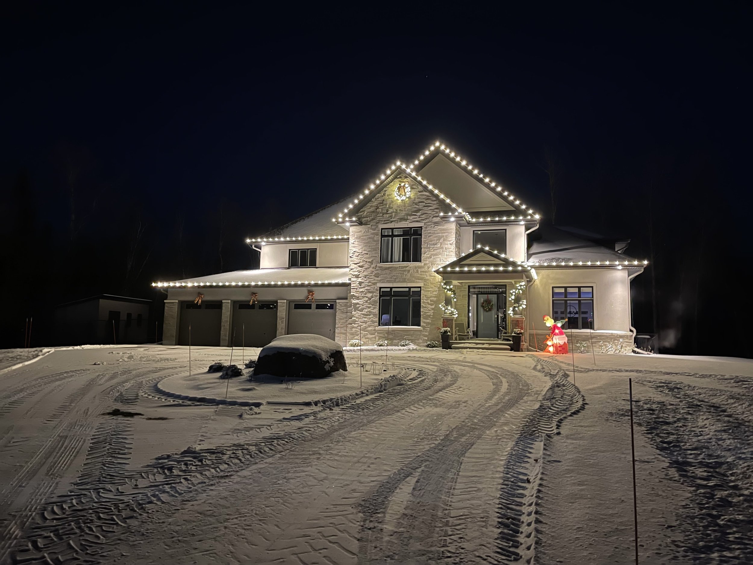 Snow-covered Thunder Bay home brightly decorated with Christmas lights