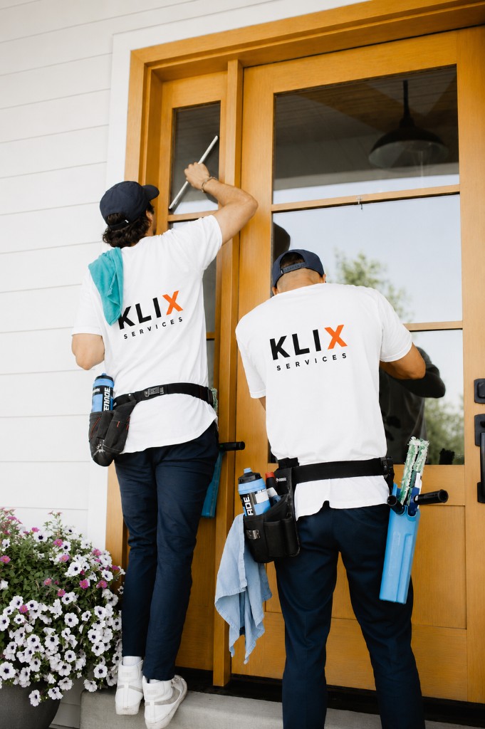 Klix crew cleaning wood-framed door glass on a Thunder Bay home