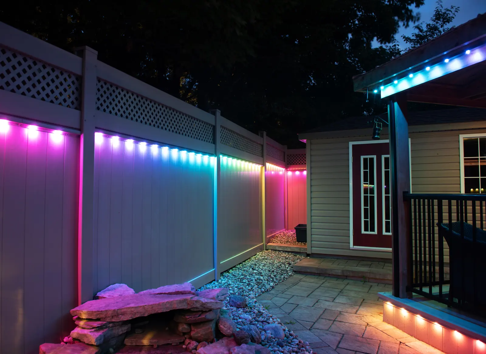 Permanent LED lighting along a backyard roofline on a Thunder Bay home