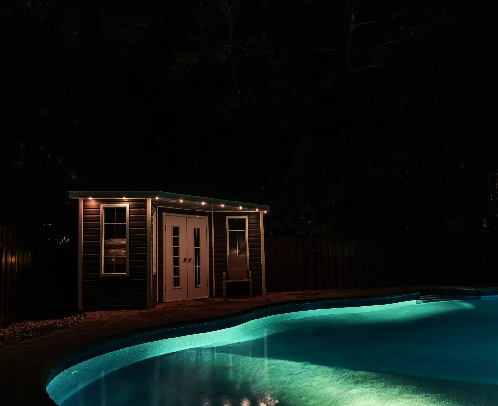 Permanent lighting around a backyard pool in Thunder Bay